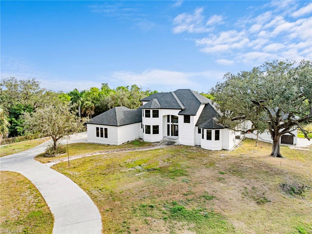 5461 Park Road Fort Myers, FL 33908 - Photo 21 of 41 a swimming pool with trees in the background