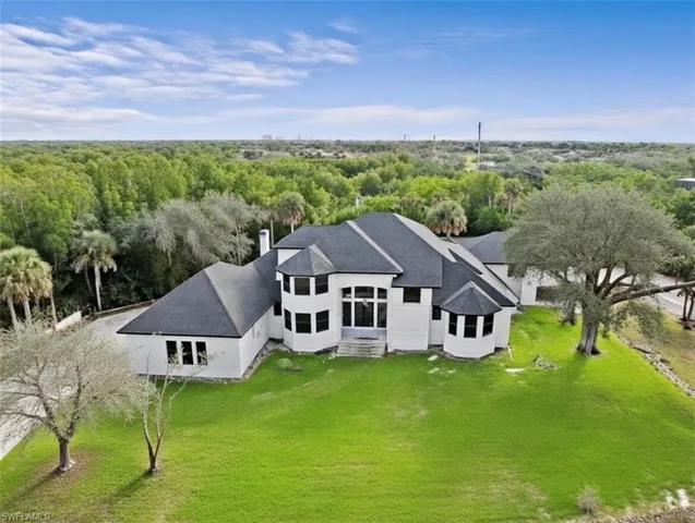 an aerial view of a house with a big yard