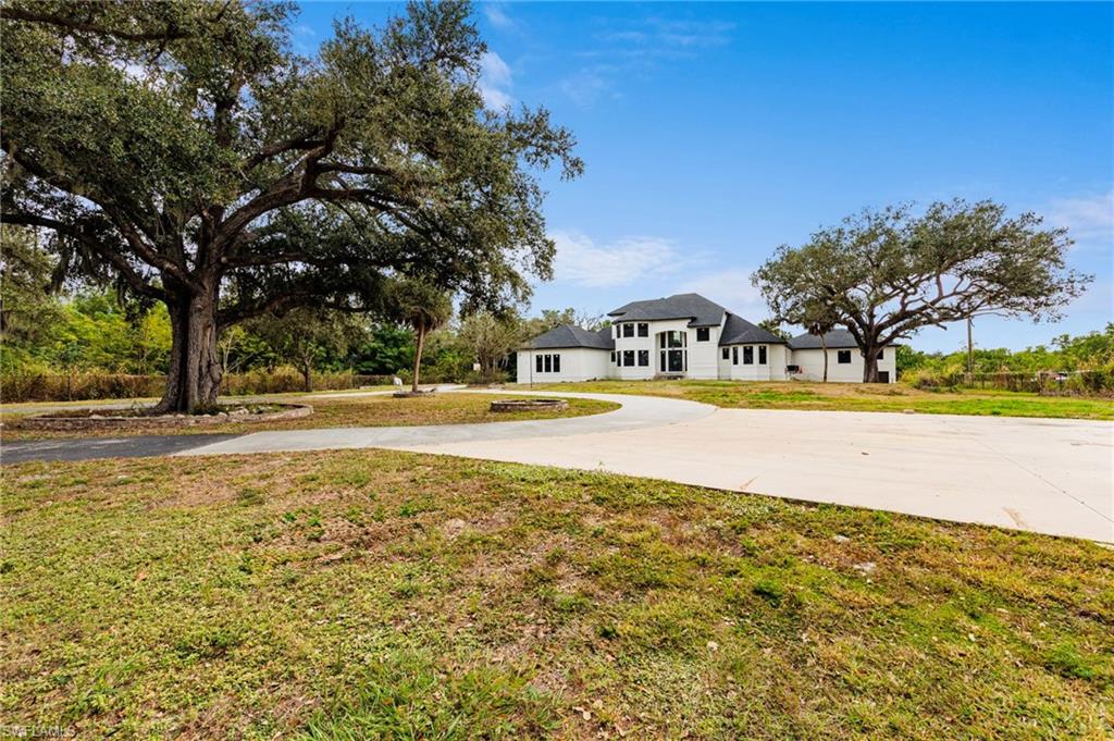 5461 Park Road Fort Myers, FL 33908 - Photo 10 of 41 a view of yard with swimming pool and trees