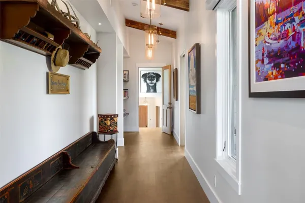 a view of hallway with stairs and wooden floor