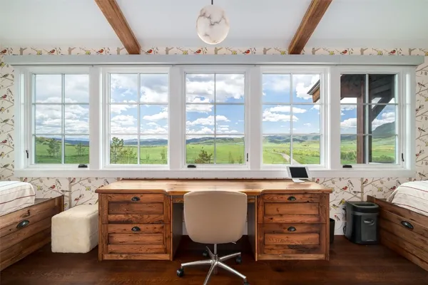 a dining area with a large window and a table