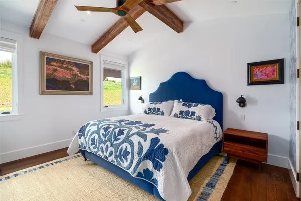 a bedroom with a bed and a window