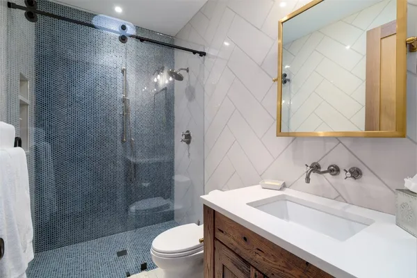 a bathroom with a sink toilet and shower