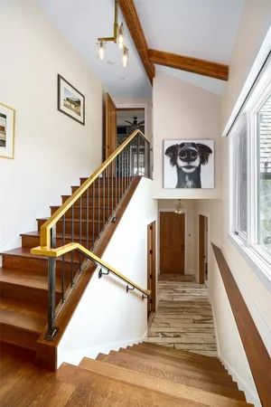 a view of entryway and hall with wooden floor