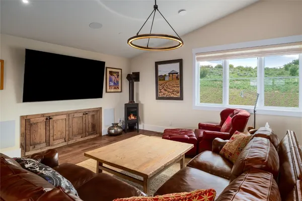 a living room with furniture a flat screen tv and a window