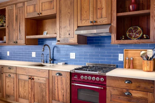 a kitchen with a stove and cabinets