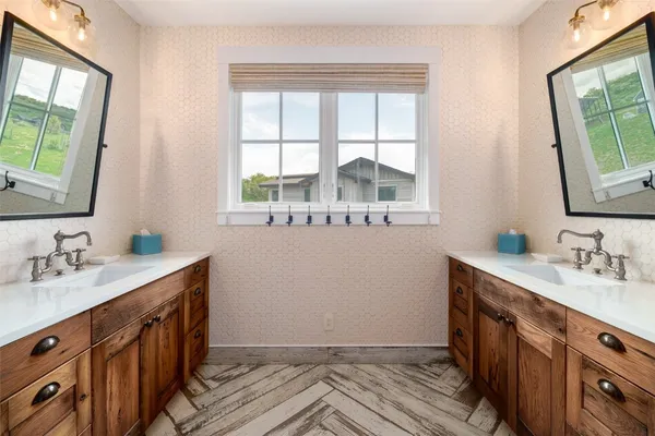 a bathroom with a sink a vanity and a window