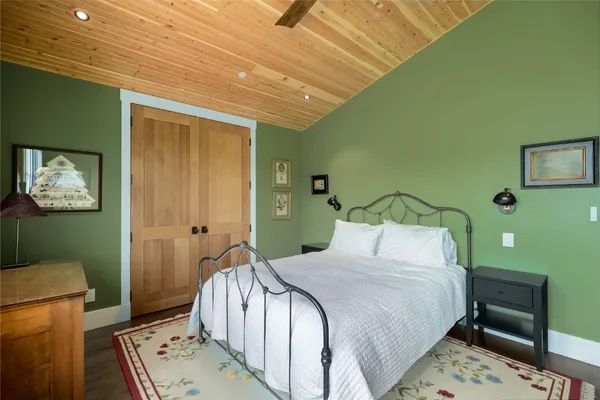 a bedroom with a bed and a table