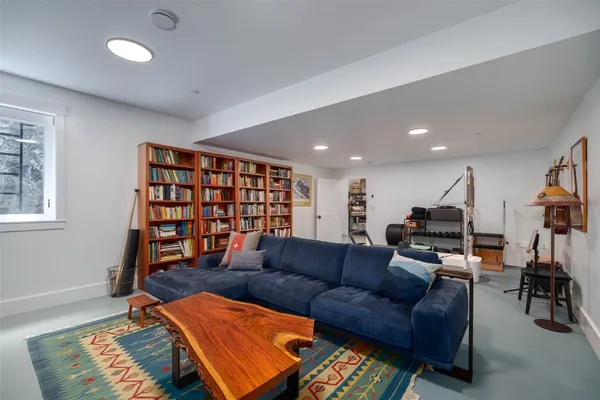a living room with furniture a air conditioner and a window