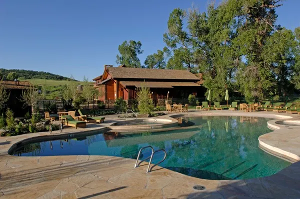 a view of a house with sitting area and swimming pool