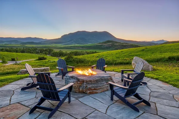 a backyard of a house with outdoor seating