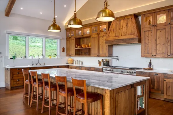 a kitchen that has a lot of cabinets in it and wooden floors