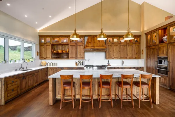 a large kitchen with a table and chairs
