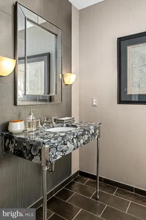 a bathroom with a granite countertop sink a toilet and mirror