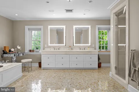 a bathroom with a granite countertop sink mirror and a bathtub
