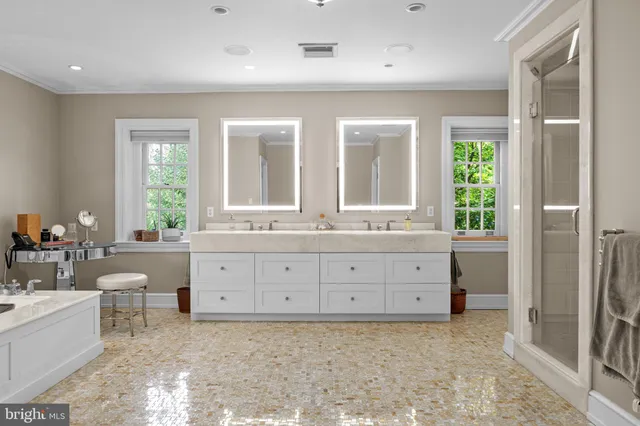 a bathroom with a granite countertop sink mirror and a bathtub