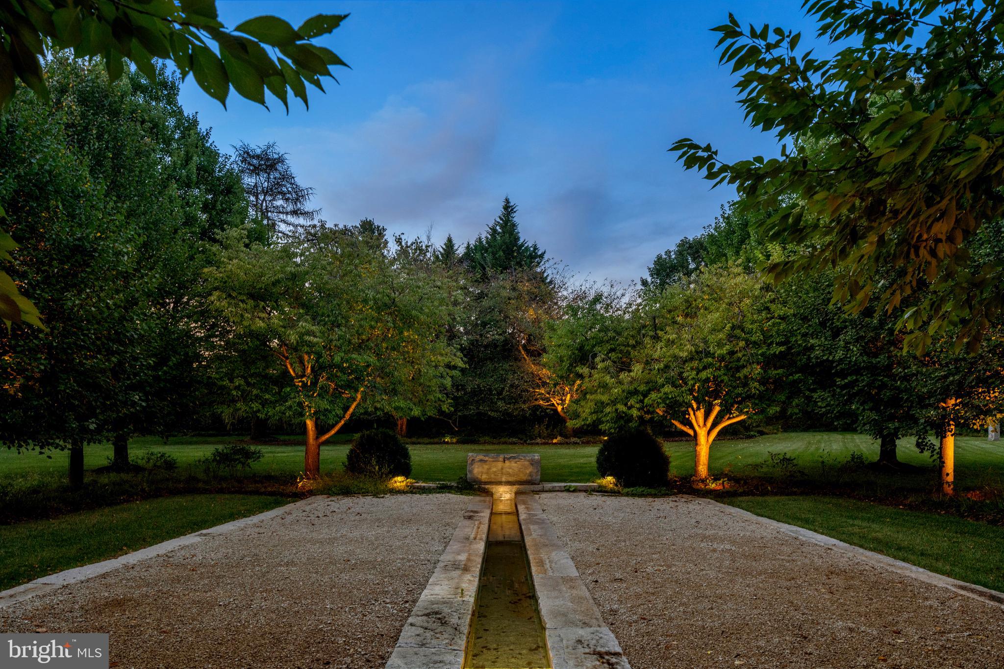 648 Creighton Road Villanova, PA 19085 - Photo 24 of 26 a backyard of a house with table and chairs plants and trees