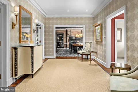 a dining room with furniture and a floor to ceiling window