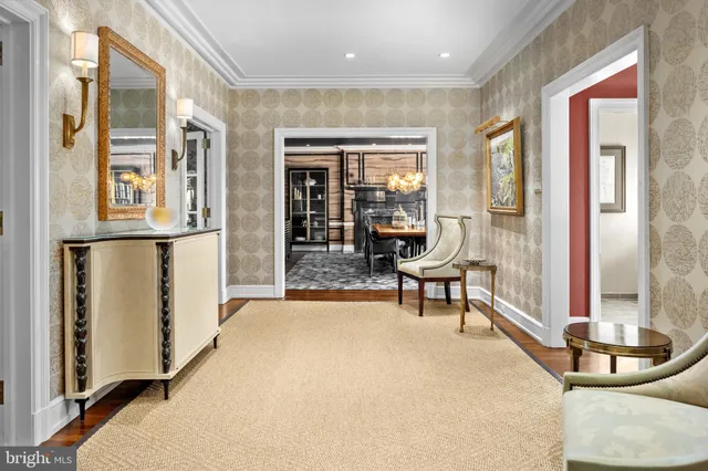 a dining room with furniture and a floor to ceiling window