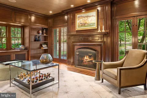 a living room with furniture a window and a fireplace