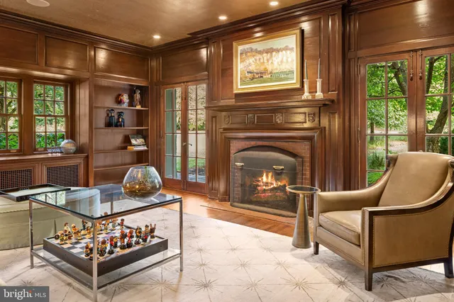 a living room with furniture a window and a fireplace