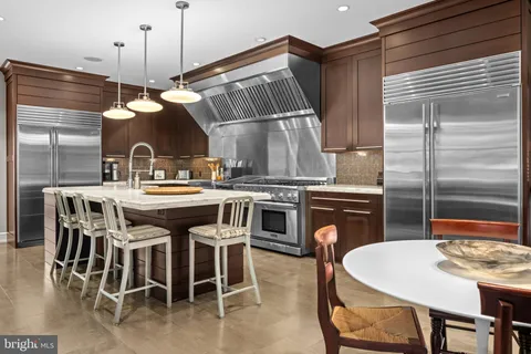 a kitchen that has a table and chairs in it