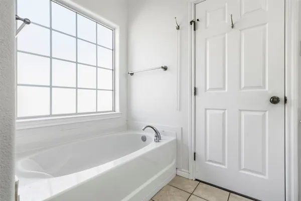 a white bath tub with a shower