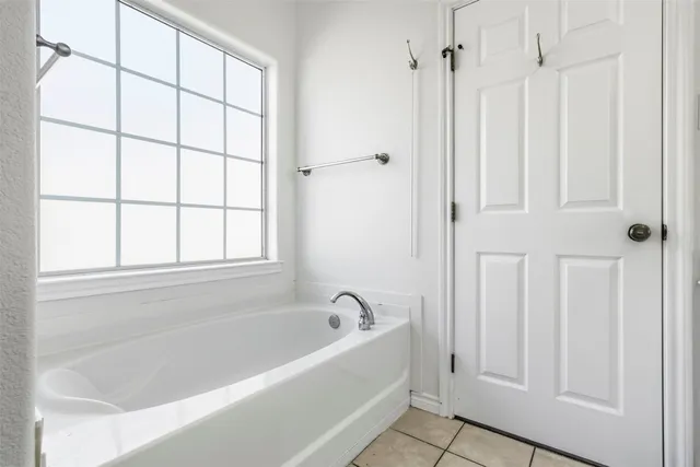a white bath tub with a shower