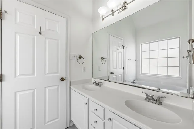 a bathroom with 2 sink and a mirror