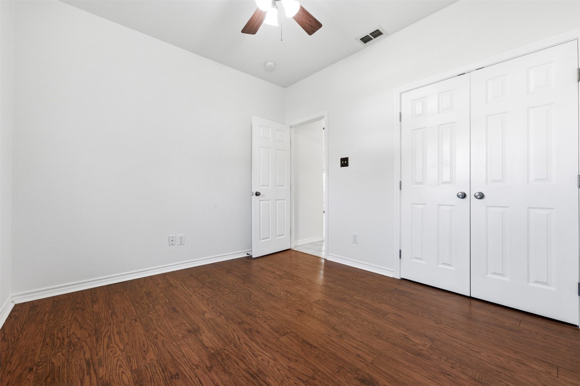 365 Rose Mayer Loop La Grange, TX 78945 - Photo 29 of 33 an empty room with wooden floor and windows