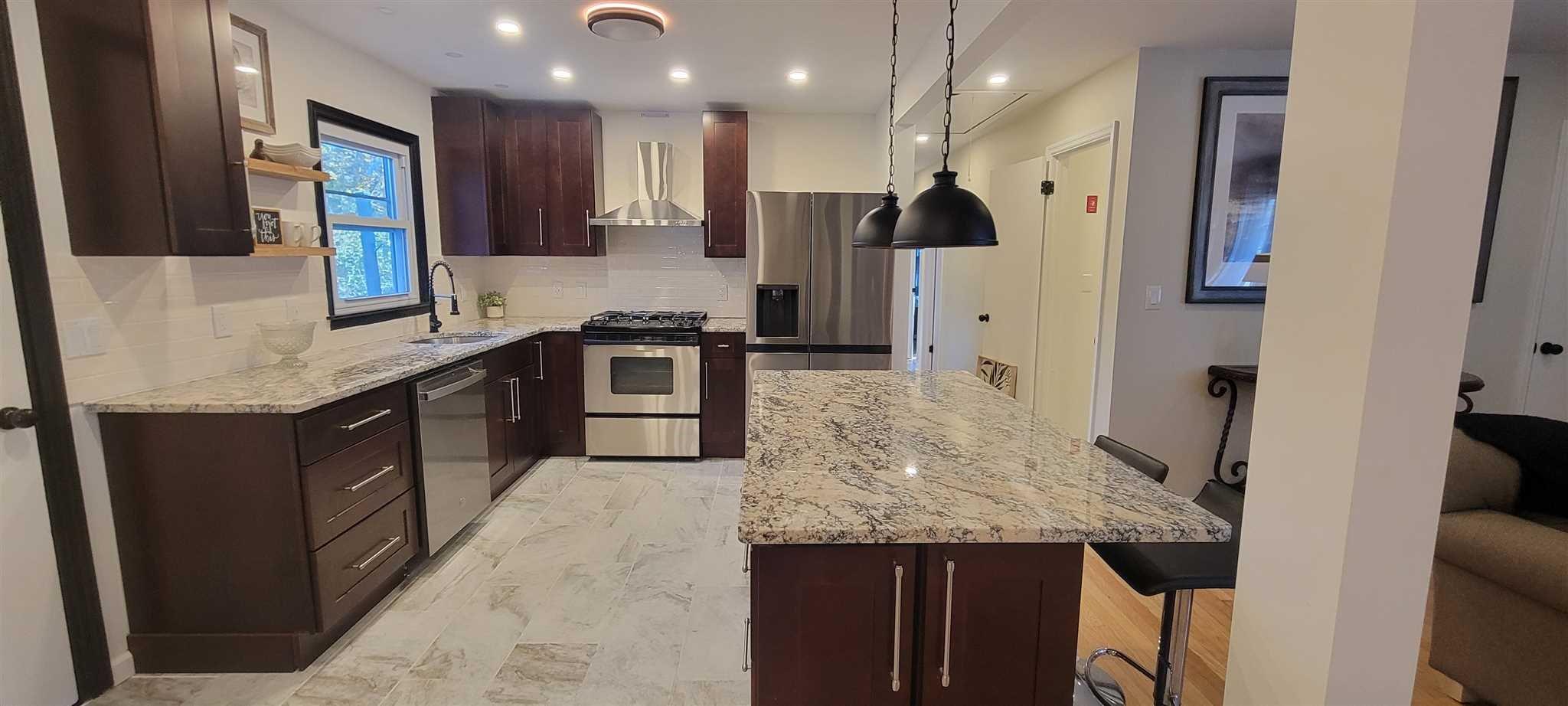 5 Haymaker Lane Plattekill, NY 12589 - Photo 5 of 37 a kitchen with stainless steel appliances granite countertop sink stove top oven and refrigerator