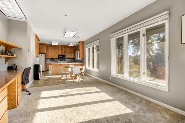 a kitchen with granite countertop a refrigerator stove top oven and sink