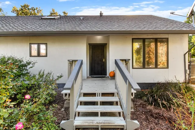 a front view of a house with a garden