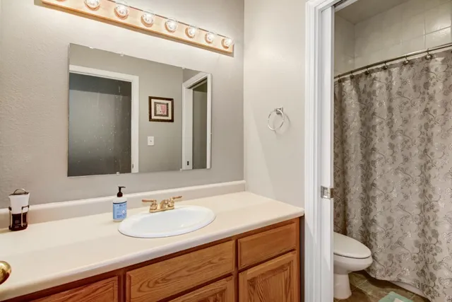 a kitchen with stainless steel appliances granite countertop a stove a microwave and a refrigerator