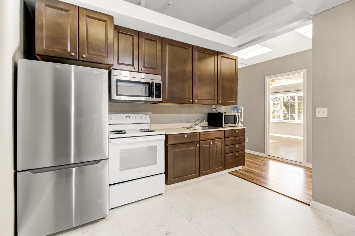 30640 County Road 86 Winters, CA 95694 - Photo 34 of 87 a kitchen with stainless steel appliances granite countertop a refrigerator a stove a sink and dishwasher with wooden floor