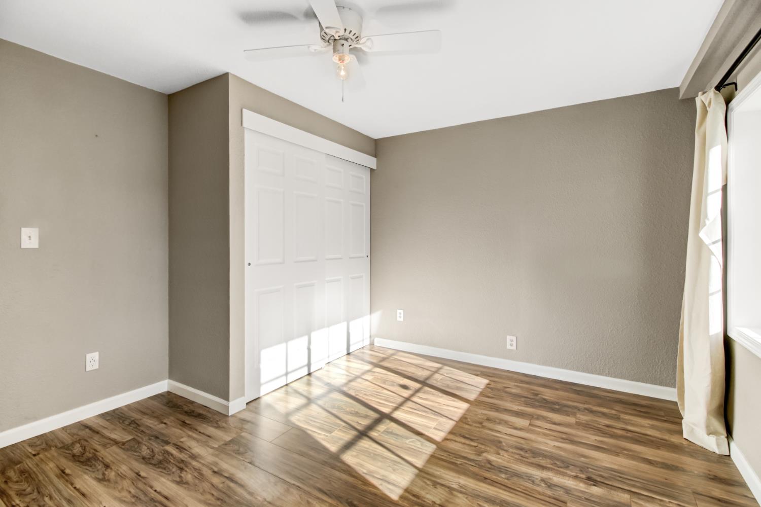 30640 County Road 86 Winters, CA 95694 - Photo 39 of 87 an empty room with wooden floor and windows