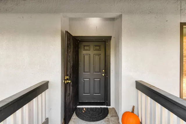 a living room with furniture ceiling fan and a window