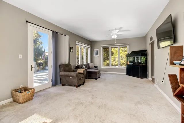 a living room with furniture and large windows