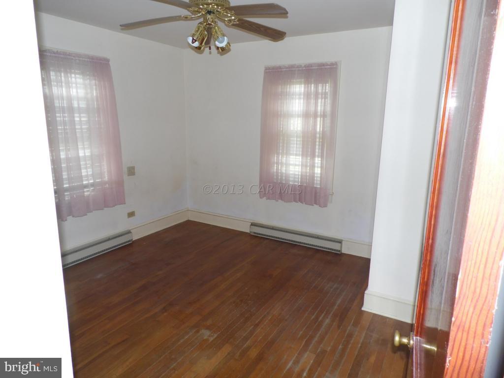 34405 Rounds Road Pittsville, MD 21850 - Photo 6 of 18 an empty room with wooden floor and windows