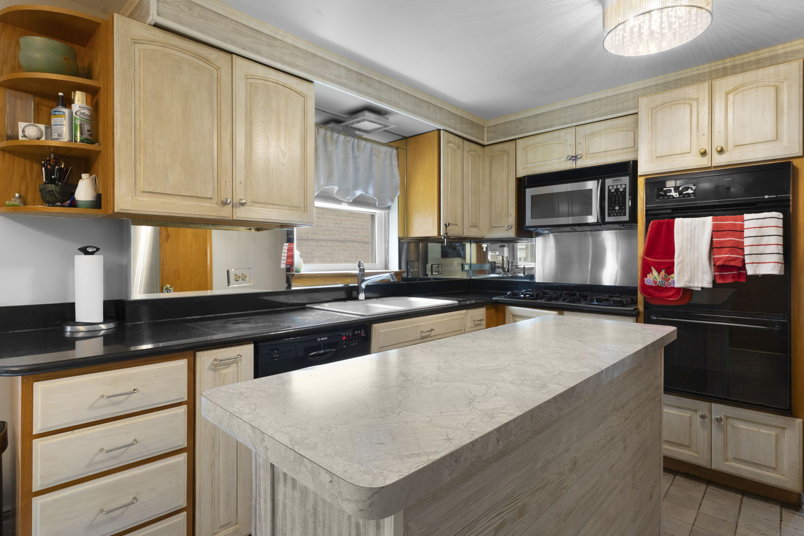 3807 Scoville Avenue Berwyn, IL 60402 - Photo 6 of 17 a kitchen with stainless steel appliances granite countertop a stove a sink and a microwave