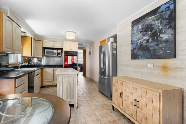 a kitchen with stainless steel appliances a refrigerator and a stove top oven