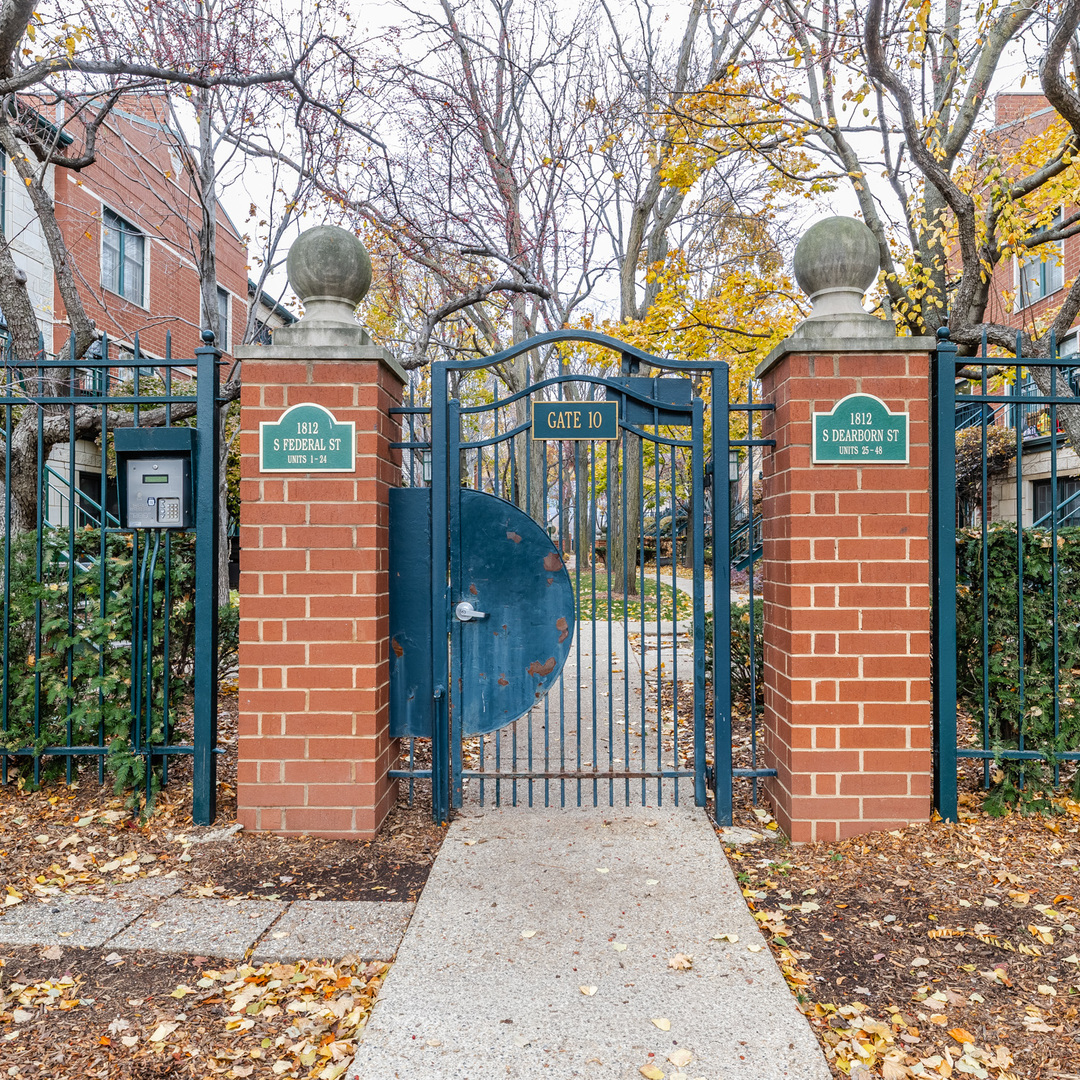 1812 South Federal Street, Unit 16 Chicago, IL 60616 - Photo 1 of 32 a view of a brick house with a large trees