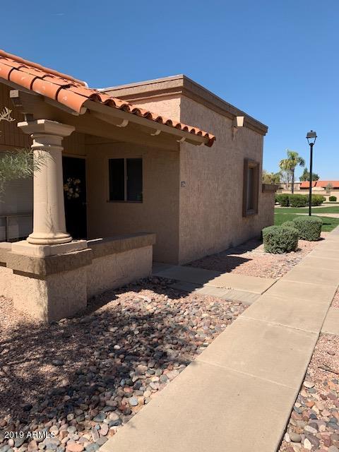 99 North Cooper Road, Unit 136 Chandler, AZ 85225 - Photo 1 of 19 a front view of a house with a yard