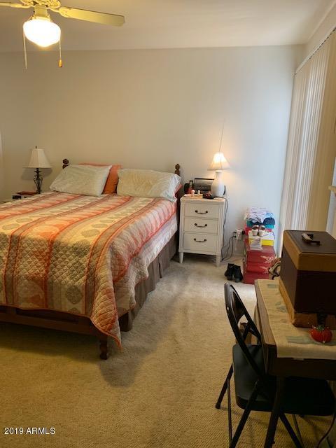 99 North Cooper Road, Unit 136 Chandler, AZ 85225 - Photo 13 of 19 a bedroom with a bed and a table