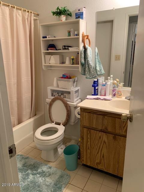 99 North Cooper Road, Unit 136 Chandler, AZ 85225 - Photo 15 of 19 a bathroom with a toilet sink and mirror