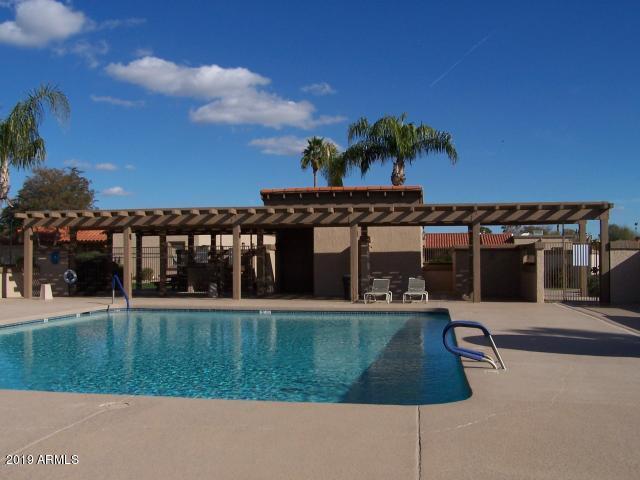 99 North Cooper Road, Unit 136 Chandler, AZ 85225 - Photo 19 of 19 a view of a house with a yard and potted plants