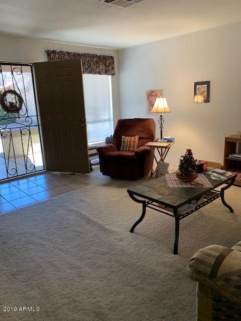 99 North Cooper Road, Unit 136 Chandler, AZ 85225 - Photo 5 of 19 a living room with furniture and wooden floor