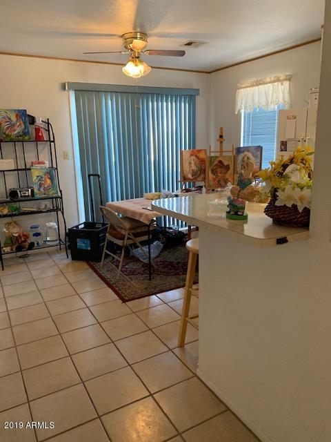 99 North Cooper Road, Unit 136 Chandler, AZ 85225 - Photo 9 of 19 a living room with furniture a flat screen tv and a large window