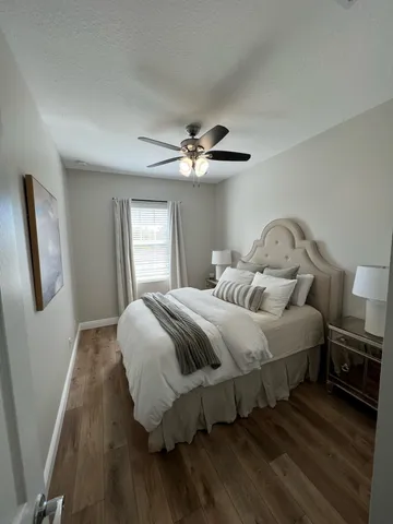 a bedroom with a bed and a ceiling fan