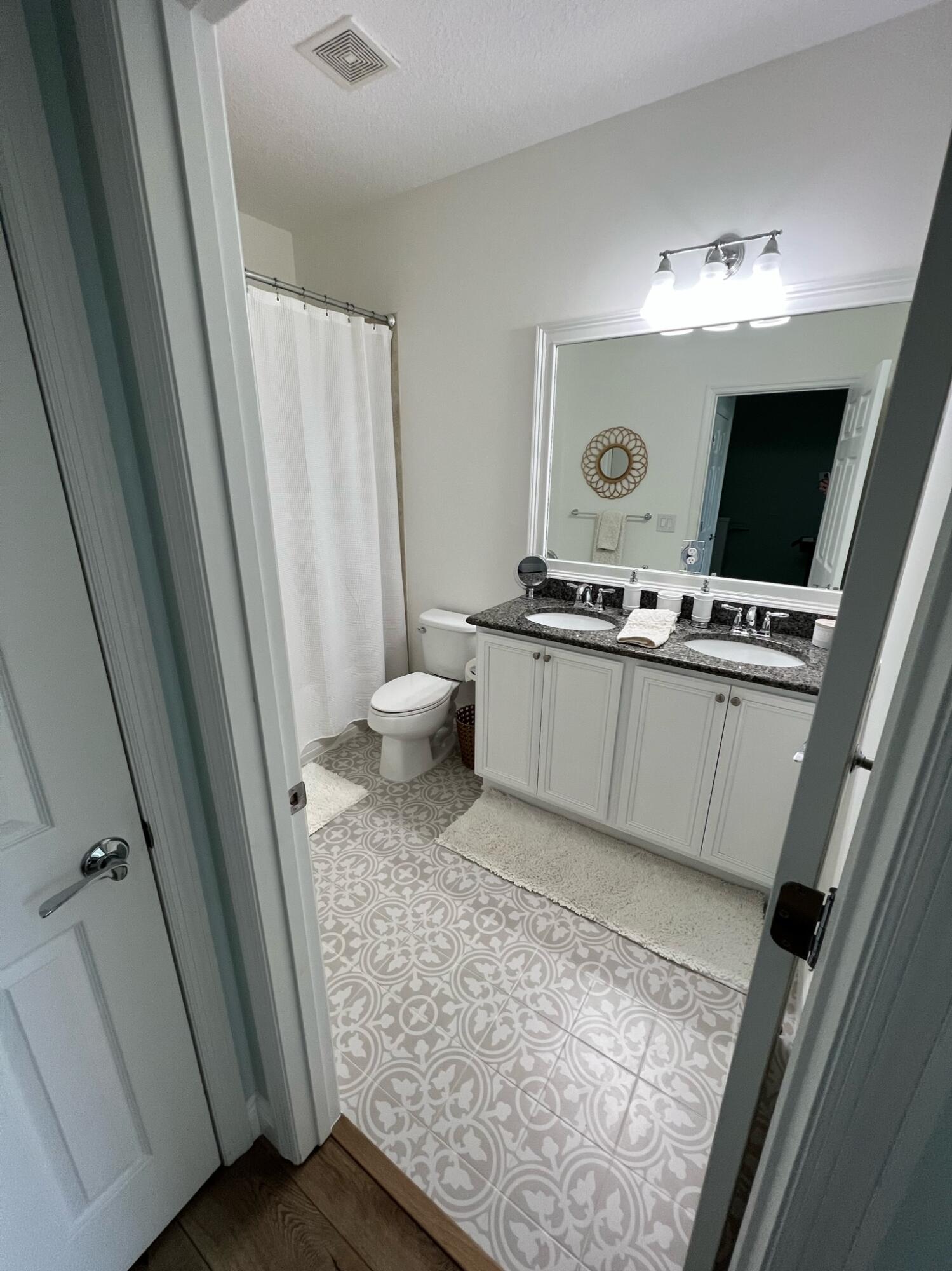 1322 Turnbridge Drive Jupiter, FL 33458 - Photo 17 of 19 a view of bathroom with a sink mirror and toilet